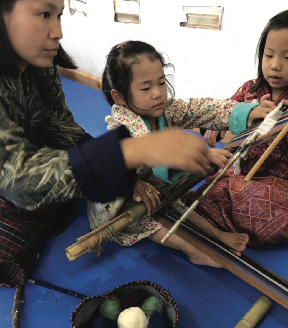 Children learning to weave