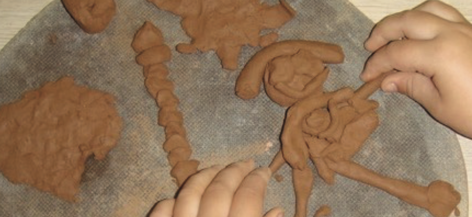 Children working with clay forms